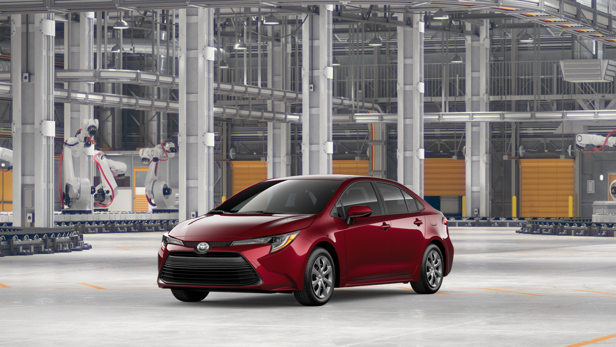 2026 Toyota Corolla LE in Ruby Flare Pearl — front three-quarter view